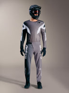 Alpinestars A-Supra Elite MTB gear in faded gray, featuring performance jersey and pants with bold white logos.