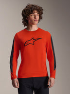 Alpinestars A-Dura Insert Astar Jersey - Long Sleeve, Spicy Orange with black Astar logo, featuring dark gray durable sleeve inserts, worn by a male model, performance MTB cycling apparel