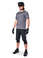 Alpinestars A-Dura Dri Astar Short Sleeve Jersey, Dark Gray, white Astars logo on chest, worn by model with black mountain bike shorts, helmet, sunglasses, and gloves, complete off-road cycling gear