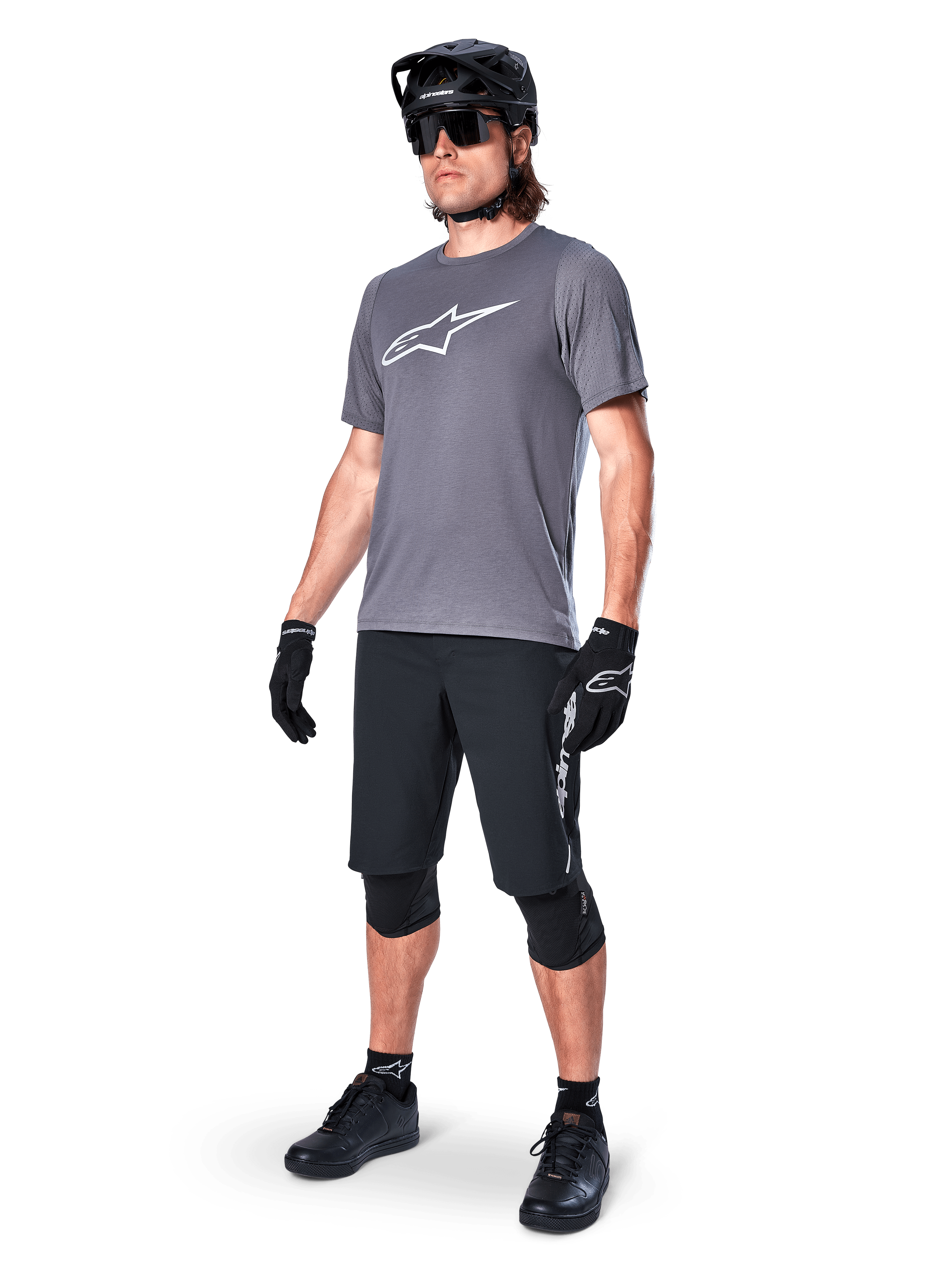 Alpinestars A-Dura Dri Astar Short Sleeve Jersey, Dark Gray, white Astars logo on chest, worn by model with black mountain bike shorts, helmet, sunglasses, and gloves, complete off-road cycling gear