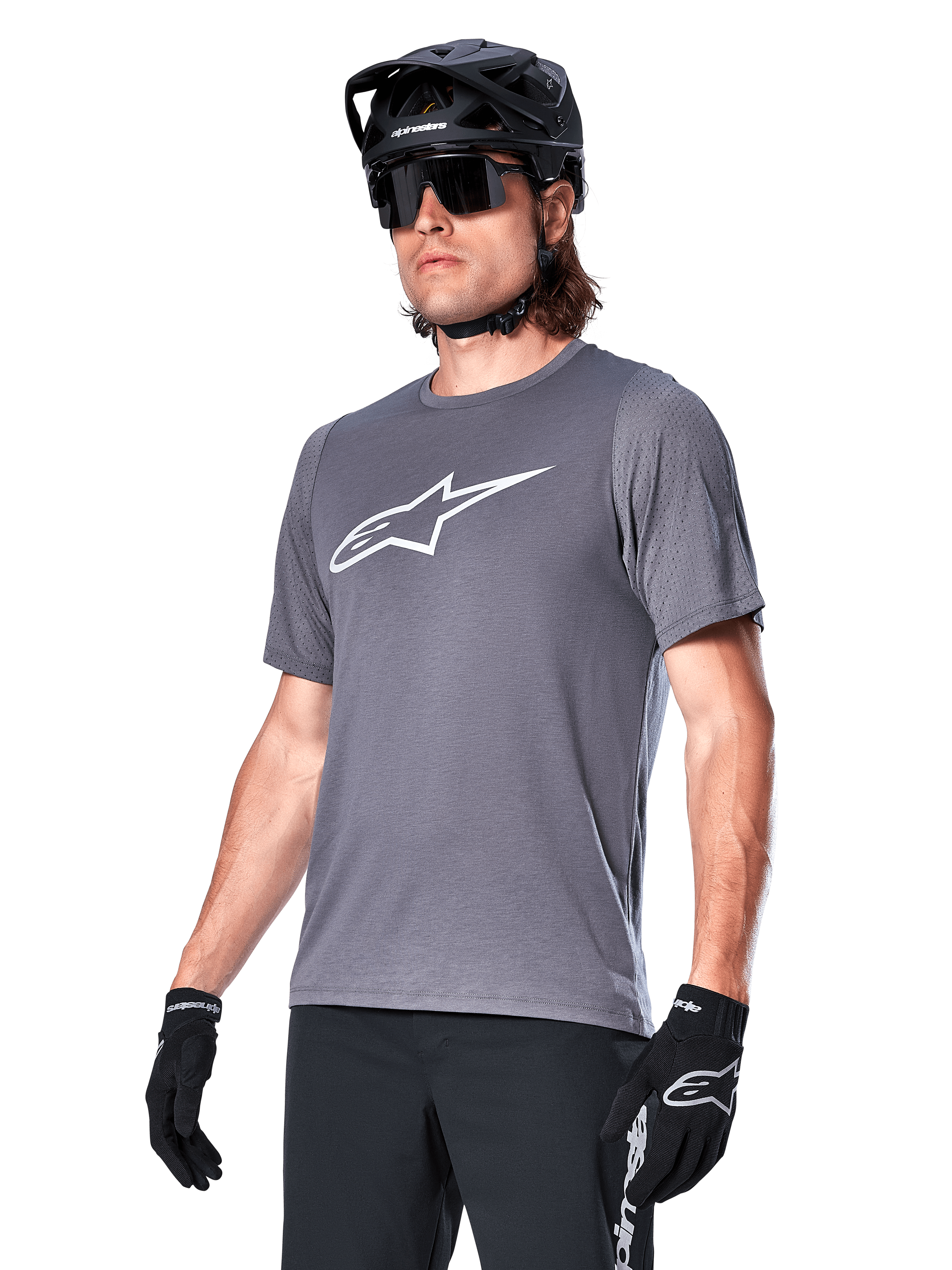 Alpinestars A-Dura Dri Astar Short Sleeve Jersey, Dark Gray, white chest logo and mesh sleeve panels, worn with black MTB helmet, sunglasses, and gloves, performance mountain biking apparel