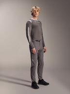 Alpinestars A-Dura Elite Pants, Mountain Bike Pants, Dark Gray, worn with a matching long-sleeve jersey and black shoes, featuring a front ratchet closure and durable Cordura fabric for trail and enduro riding