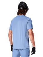 Alpinestars A-Dura Astar Short Sleeve Men's MTB Jersey in Infinity Blue, rear view on a rider for off-road trail riding.