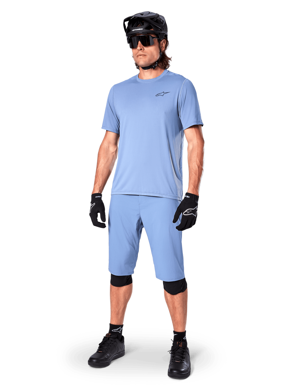 Alpinestars A-Dura Astar Jersey, Men's Infinity Blue MTB shirt, with matching shorts and black protective gear.