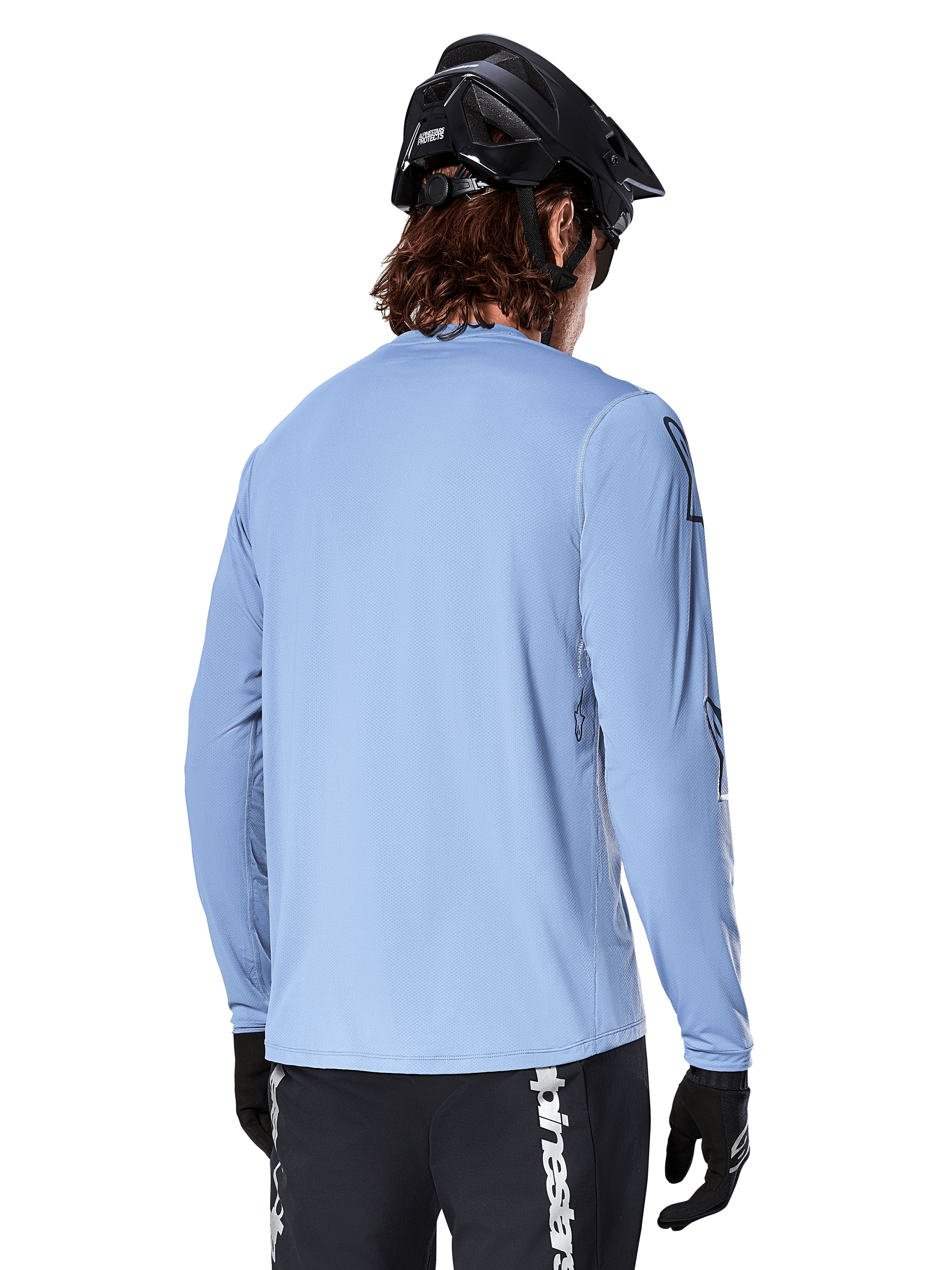 Alpinestars A-Dura Switch Long Sleeve Jersey, Infinity Blue, rear view of mountain bike rider wearing a black helmet and shorts, casual performance cycling apparel with a drop-tail hem.