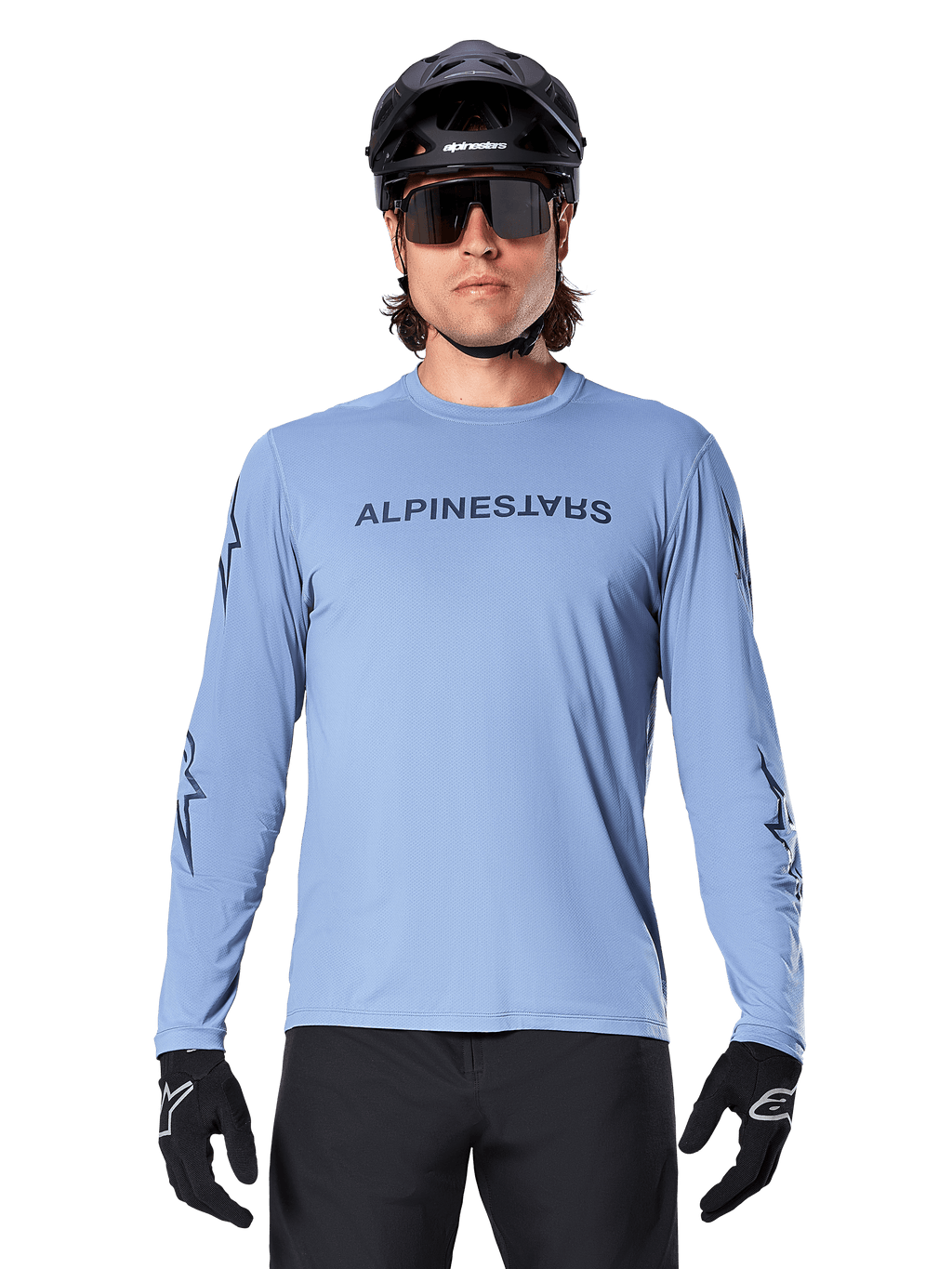 Alpinestars A-Dura Switch Long Sleeve Jersey, Infinity Blue, worn by a man with a black MTB helmet and sunglasses, featuring chest wordmark and sleeve graphics, performance mountain bike apparel