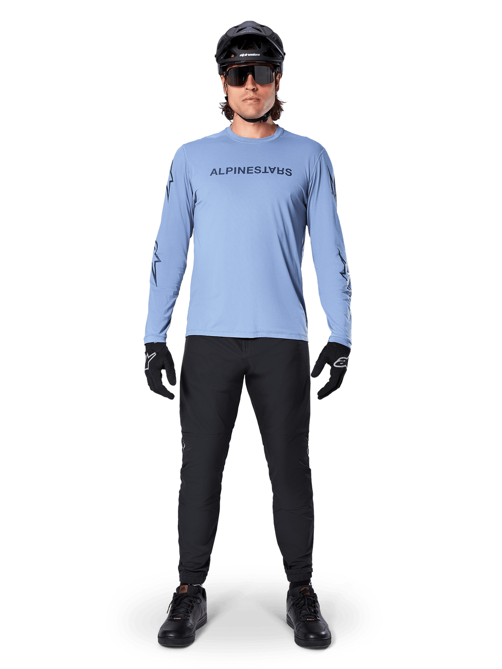 Alpinestars A-Dura Switch Jersey - Long Sleeve, Infinity Blue, worn with black mountain bike pants, black helmet, and sunglasses, featuring a chest wordmark logo graphic, performance cycling apparel for MTB.