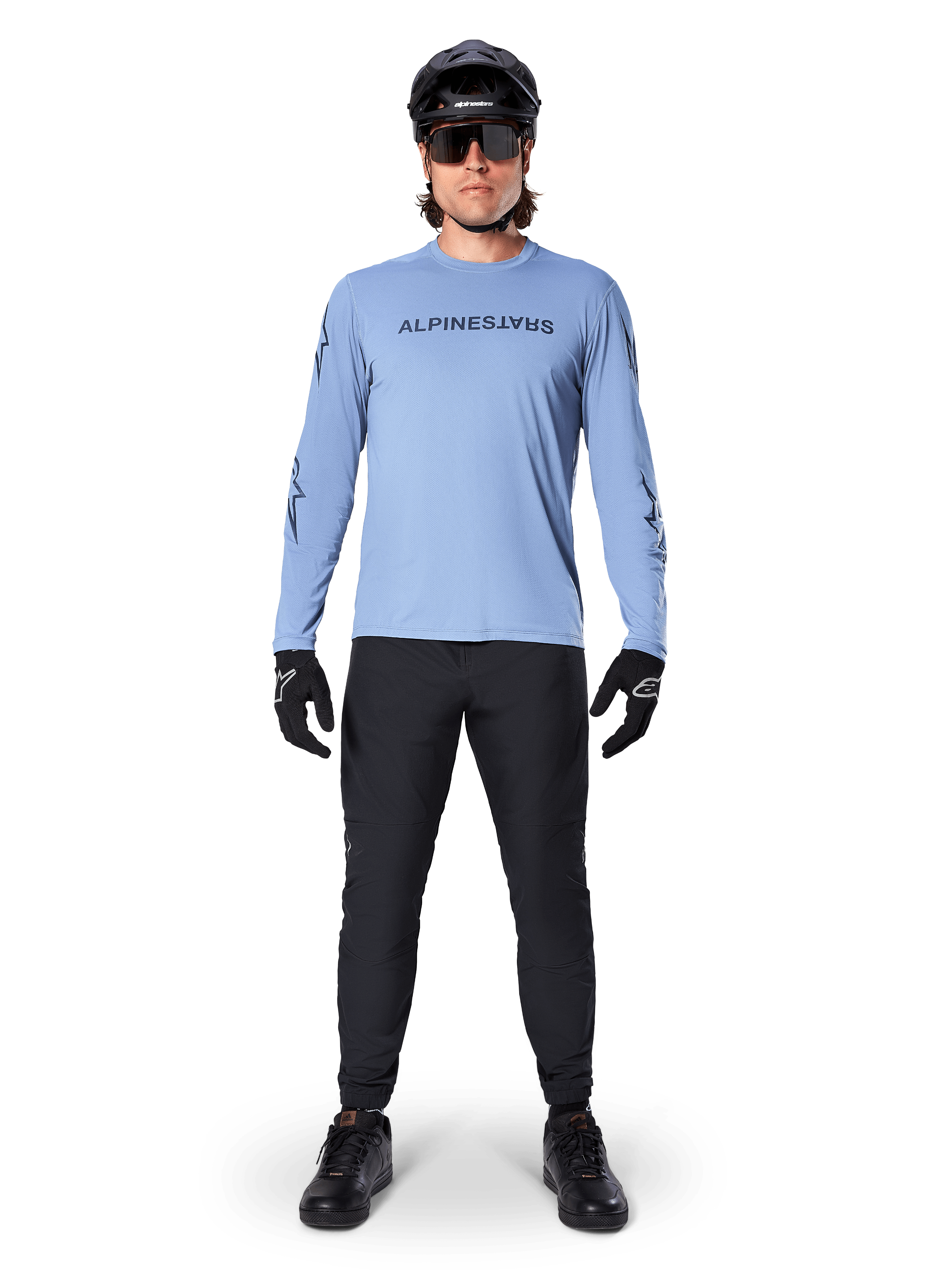 Alpinestars A-Dura Switch Jersey - Long Sleeve, Infinity Blue, worn with black mountain bike pants, black helmet, and sunglasses, featuring a chest wordmark logo graphic, performance cycling apparel for MTB.