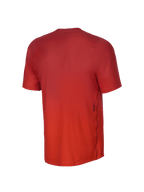 Alpinestars Youth A-Dura Rise Short Sleeve Jersey, Back View, Spicy Orange, featuring a jacquard fabric texture, a small black Astars logo on the lower side, and a dropped tail hem for mountain biking coverage.