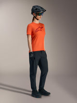 Orange Stella A-Dura Ride Short Sleeve Jersey with red chest logo, technical women's MTB apparel for trail performance.
