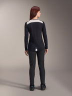 Alpinestars Women Stella A-Dura Pants and Stella A-Dura Elite Jersey, MTB riding gear, Black with white shoulder panel, viewed from behind, technical outdoor apparel for mountain biking, paired with black shoes