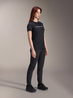 Alpinestars Stella A-Dura Dri Switch Jersey, Short Sleeve Cycling Jersey, Black with white Alpinestars logo, worn by female model with matching black pants and shoes, versatile gear for mountain biking.