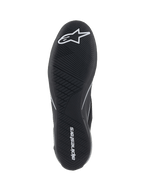 Alpinestars Supertech Shoes, Auto Racing Shoes, Black, bottom view of the ultra-thin rubber outsole with white star logo and alpinestars wordmark, featuring an asymmetric tread pattern for pedal sensitivity and grip