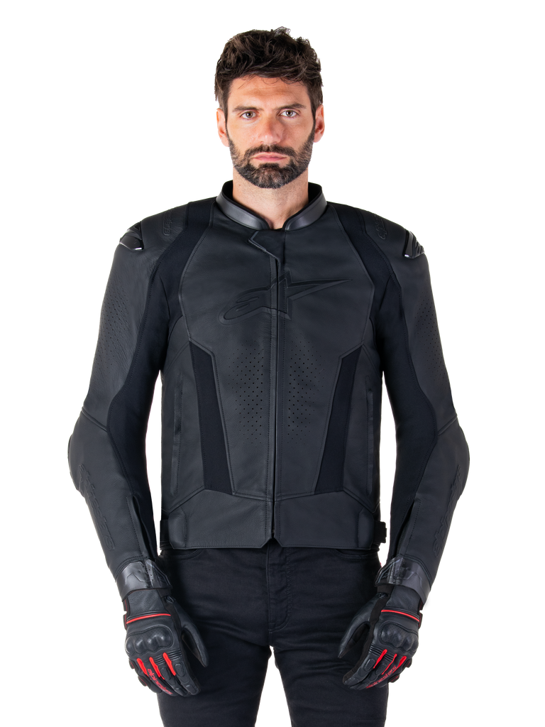 Alpinestars Missile V3 Leather Jacket, Black Motorcycle Racing Jacket, worn by model with matching black gloves and pants, featuring perforated leather for ventilation, external shoulder sliders, and sleek sport riding design