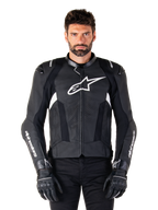 Alpinestars Missile V3 Leather Jacket, Black with White Logos, worn by a model with black riding gloves, premium leather motorcycle racing jacket with perforated ventilation panels and performance riding features