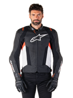 Alpinestars Missile V3 Leather Jacket, Black White and Red Fluo, premium racing sport jacket with bovine leather, featuring white chest logo and Alpinestars branding on sleeves, worn with black motorcycle gloves and pants