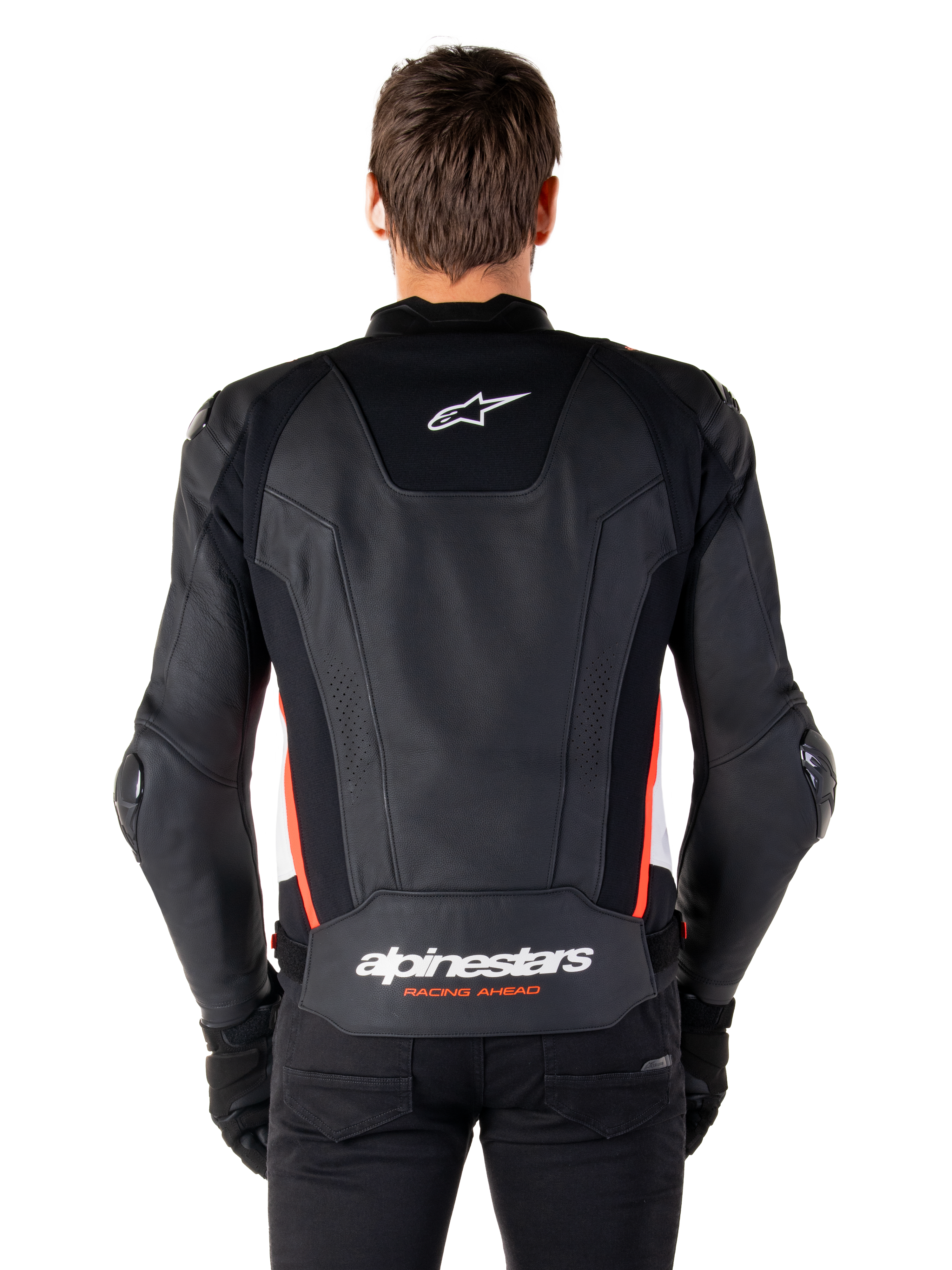 Alpinestars Missile V3 Leather Jacket, back view, premium black leather with red fluo and white accents, featuring a white star logo on the upper back and Alpinestars branding on the lower back, worn with black pants and gloves.
