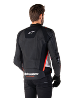 Alpinestars Missile V3 Leather Jacket, back view on a rider, Black White and Red Fluo, featuring bold Alpinestars branding and 'RACING AHEAD' text on the lower back, premium leather construction with technical stretch panels and protective TPU sliders, worn with black gloves and trousers.