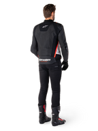 Alpinestars Missile V3 Leather Jacket in Black White Red Fluo, back view on a male rider, featuring Alpinestars branding on the upper and lower back, paired with black pants and motorcycle boots, racing-inspired leather sport jacket.