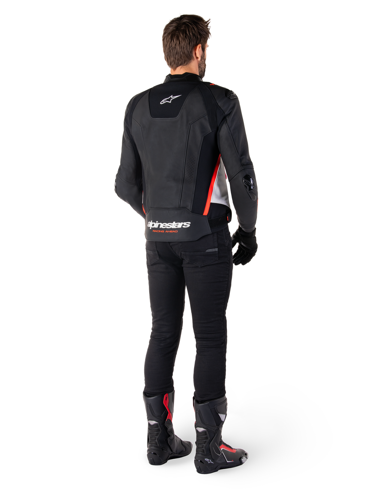 Alpinestars Missile V3 Leather Jacket in Black White Red Fluo, back view on a male rider, featuring Alpinestars branding on the upper and lower back, paired with black pants and motorcycle boots, racing-inspired leather sport jacket.