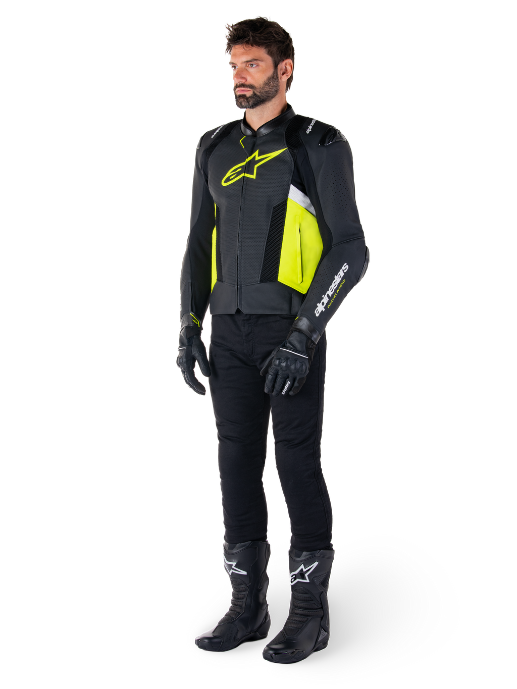 Male model wearing the Alpinestars Missile V3 Airflow Leather Jacket in Black, Yellow Fluo, and White, styled with black riding gloves, pants, and boots, showcasing the perforated leather design and racing-inspired aesthetic.