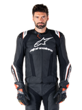 Alpinestars Missile V3 Ignition Leather Jacket, Black with white and red accents, worn by a male model with matching racing gloves and pants, MotoGP-derived sport motorcycle jacket with bold branding