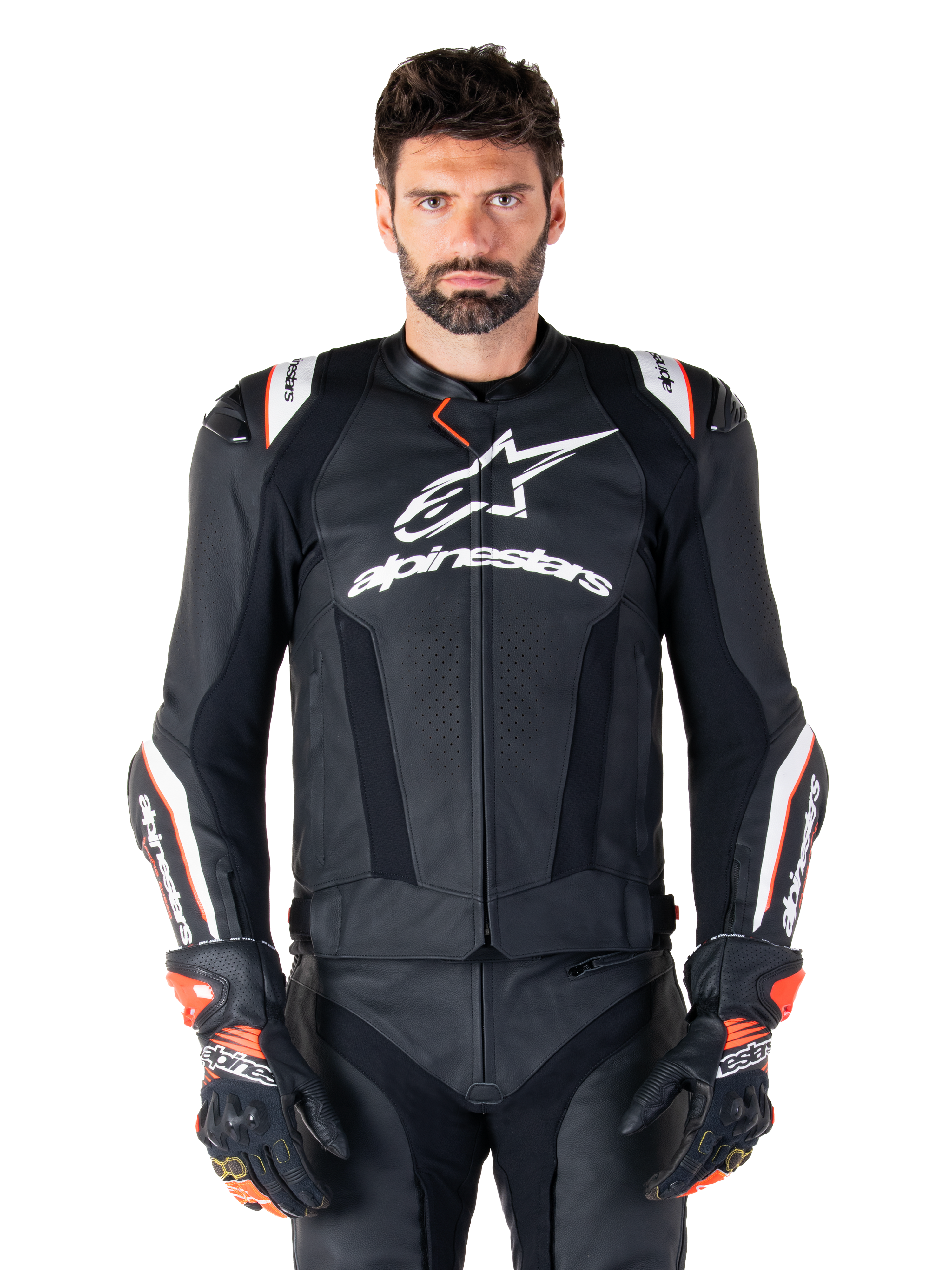 Alpinestars Missile V3 Ignition Leather Jacket, Black with white and red accents, worn by a male model with matching racing gloves and pants, MotoGP-derived sport motorcycle jacket with bold branding