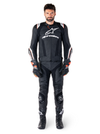 Male rider wearing the Alpinestars Missile V3 Ignition Leather Jacket in Black, paired with matching leather pants, gloves, and boots, featuring white Alpinestars branding and red accents, designed for professional racing performance.