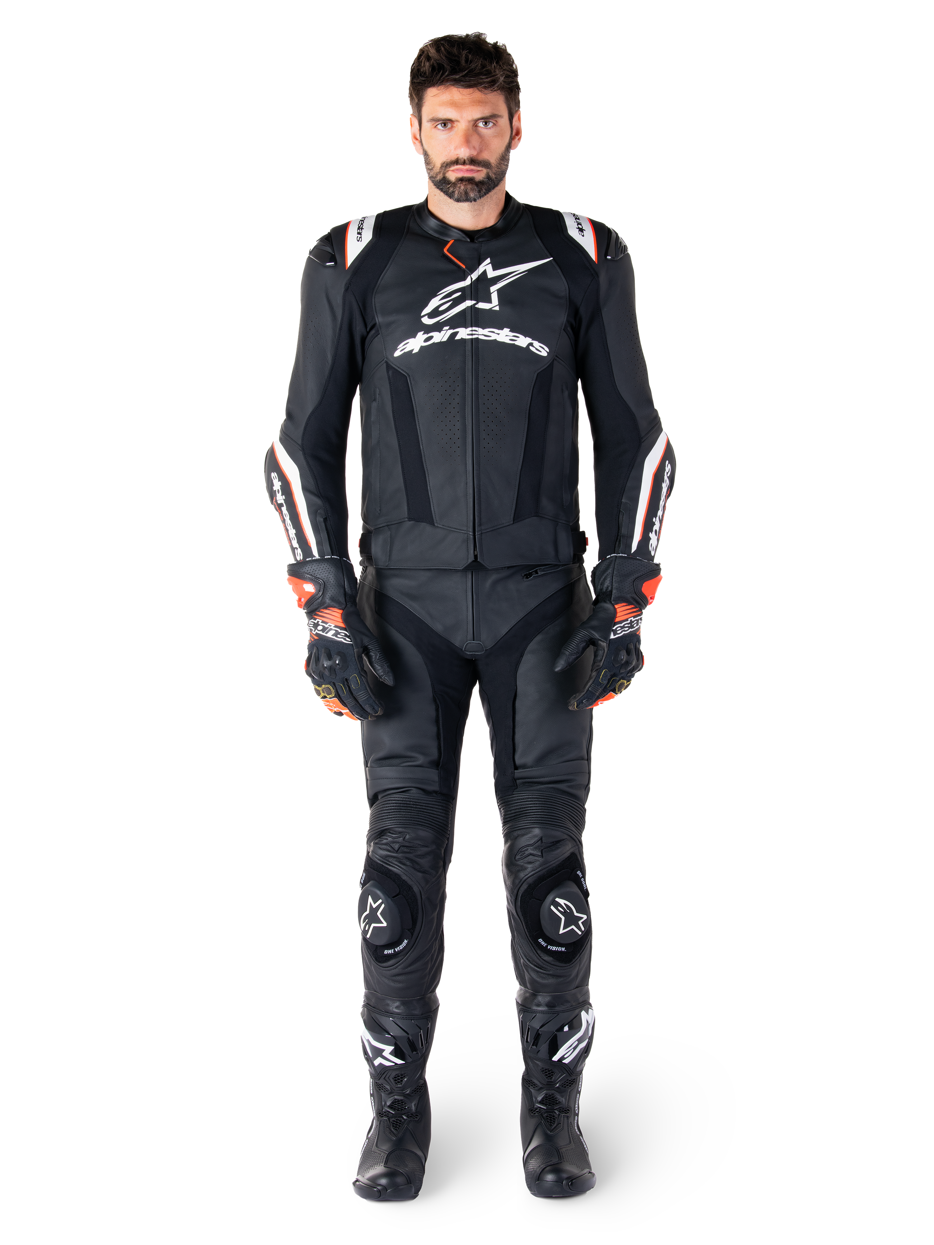 Male rider wearing the Alpinestars Missile V3 Ignition Leather Jacket in Black, paired with matching leather pants, gloves, and boots, featuring white Alpinestars branding and red accents, designed for professional racing performance.