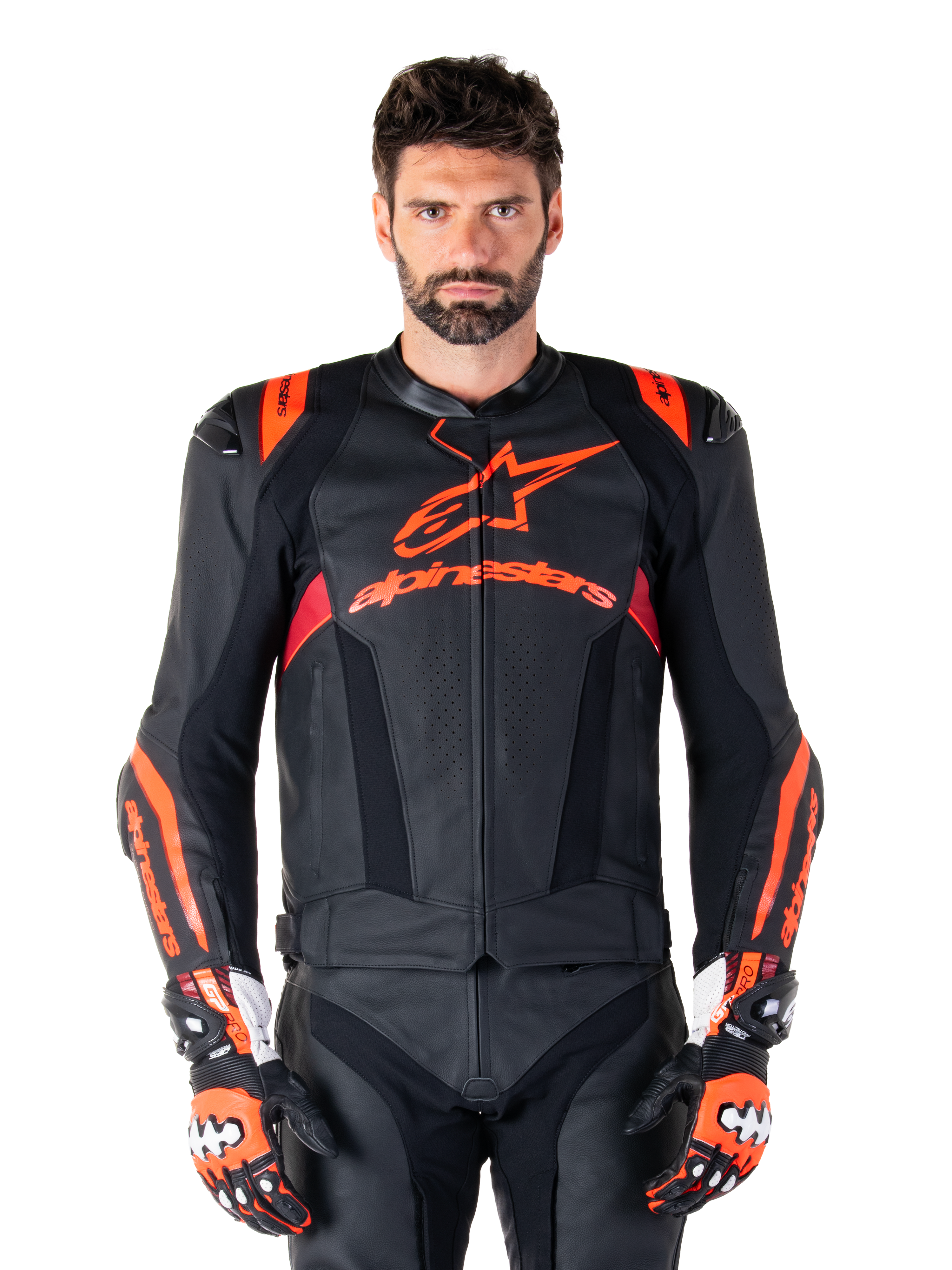 Alpinestars Missile V3 Ignition Leather Jacket, Motorcycle Racing Jacket, Black and Red Fluo, worn with matching racing gloves and leather pants, featuring perforated ventilation and prominent Alpinestars branding, professional racing gear