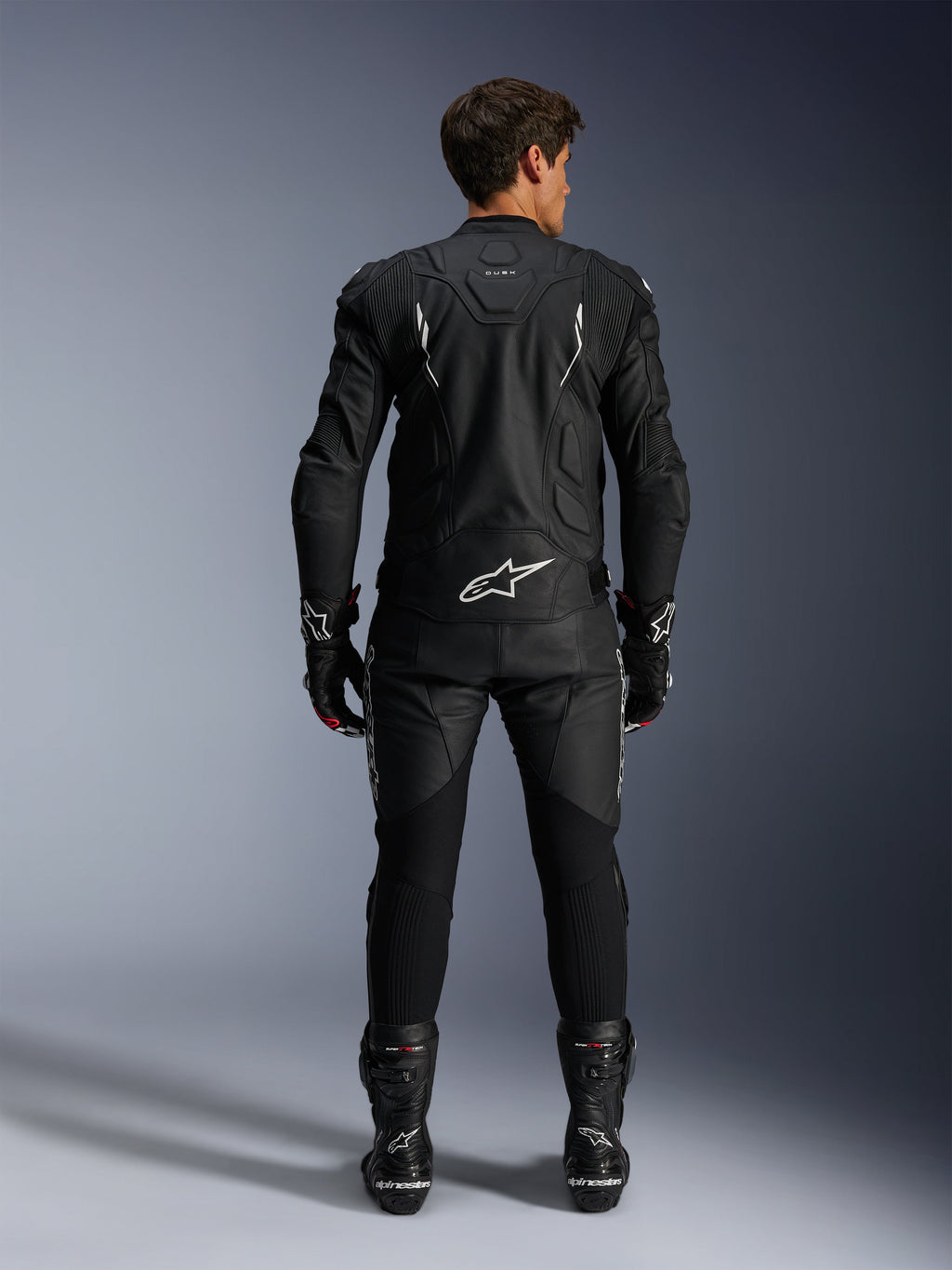 Alpinestars Dusk Leather Jacket AND Missile V3 Leather Pants, men's black and white leather racing suit, rear view.