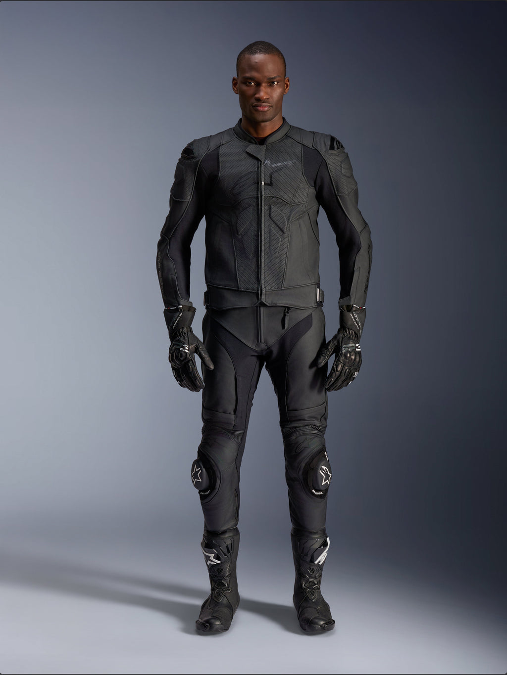 Alpinestars Dusk Airflow Leather Jacket, Black, worn with matching motorcycle pants, gloves, and boots, featuring perforated leather for maximum airflow, ergonomic multi-panel design, and internal armor, professional road and sport riding gear