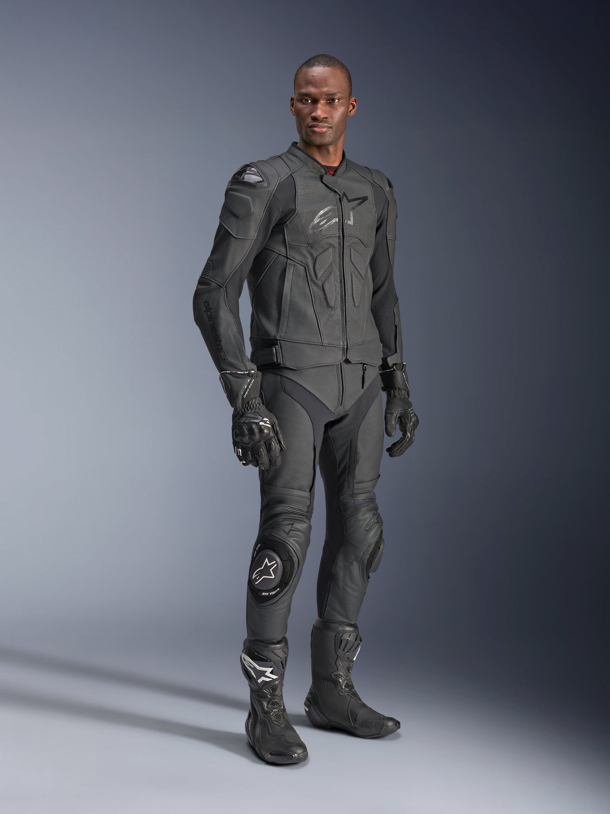 Alpinestars Dusk Airflow Leather Jacket, Black Black, worn by a rider in full technical gear including matching leather pants, gloves, and boots, featuring perforated leather panels for ventilation and integrated armor for sport motorcycle riding
