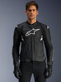 Alpinestars Dusk Airflow Leather Jacket, Black and White, leather motorcycle jacket worn by a model, featuring perforated leather panels for ventilation, a large white chest logo, and external shoulder sliders.