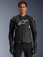 Alpinestars Dusk Airflow Leather Jacket, Black and White, leather motorcycle jacket worn by a model, featuring perforated leather panels for ventilation, a large white chest logo, and external shoulder sliders.