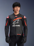 Alpinestars GP Plus R V4 Airflow Leather Jacket in Black with Red Fluo and White accents, worn by a model, featuring perforated leather construction, a large white ASTARS logo on the chest, and integrated shoulder armor for motorcycle racing.