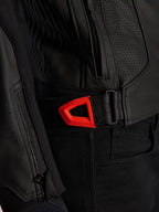 Alpinestars GP Plus R V4 Airflow Leather Jacket close-up, black perforated leather with a vibrant red fluo hook-and-loop waist adjustment strap, featuring a zippered side pocket and ergonomic textured panels.