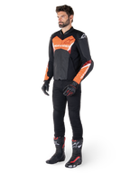 Alpinestars Faster V3 Airflow Leather Jacket, Black and Red Fluo, worn by a male model with black riding pants, gloves, and racing boots, featuring perforated leather and a sport silhouette.