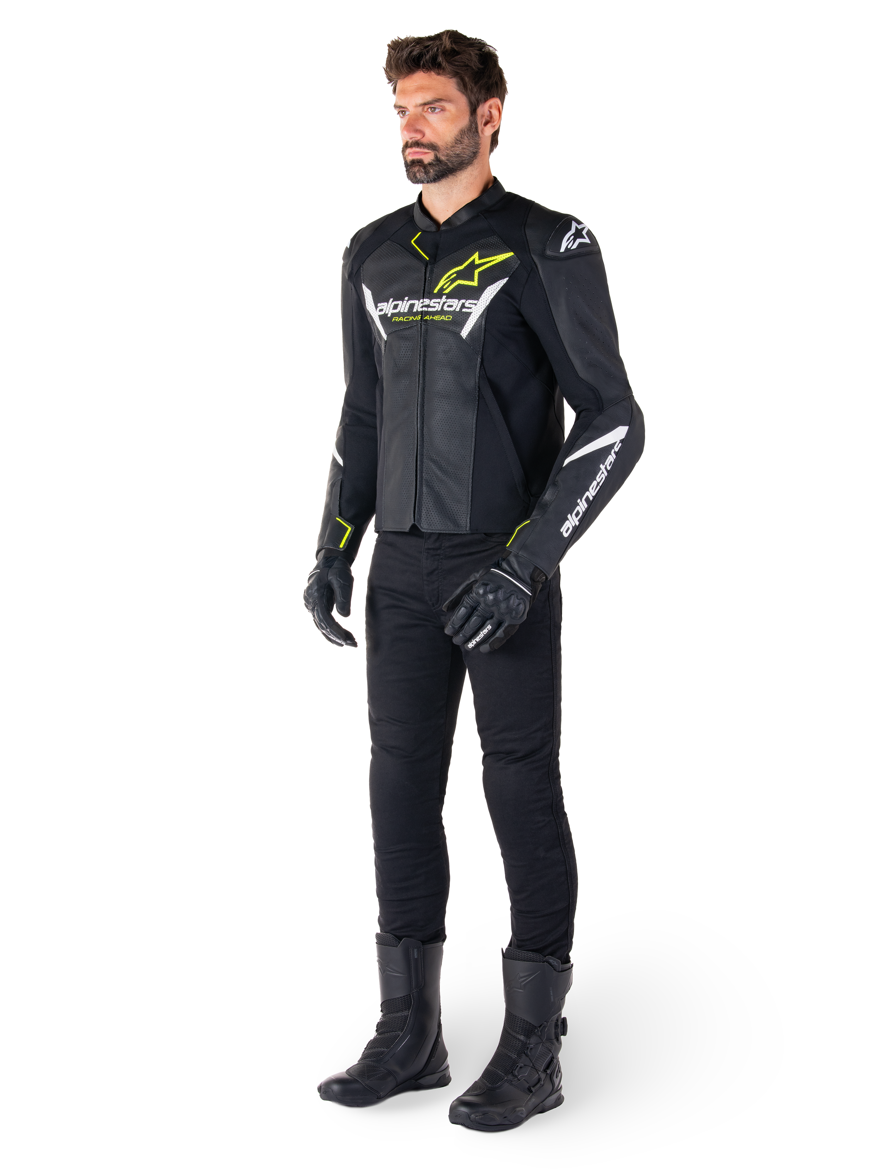 Male rider wearing the Alpinestars Faster V3 Airflow Leather Jacket in Black White and Yellow Fluo, paired with black motorcycle pants and boots, featuring perforated leather panels, white logo details, and neon yellow accents, professional sport riding gear