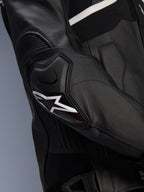 Alpinestars Atem V5 Leather Jacket, Black and White, close-up of the DFS RR elbow protector with white star logo, featuring accordion leather and perforated textures for sport riding