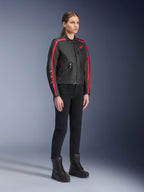 Female model wearing the Alpinestars Stella Dyno Leather Jacket in Black Haute Red, paired with black pants and boots, heritage-style leather motorcycle jacket with red stripes on the arms and red logo, urban and road riding gear for women