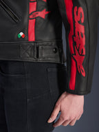 Alpinestars Stella Dyno Leather Jacket, Women's Leather Motorcycle Jacket, Black Haute Red, close-up view of waist and sleeve, red racing stripes with Alpinestars branding, adjustable waist strap, small Italian flag embroidery, premium bovine leather construction