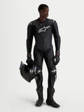 Alpinestars Missile V3 Leather Suit 1-Piece, Black men's 1-piece motorcycle racing leather suit with integrated DFS ST armor and CE AAA certification, worn by a model holding a helmet