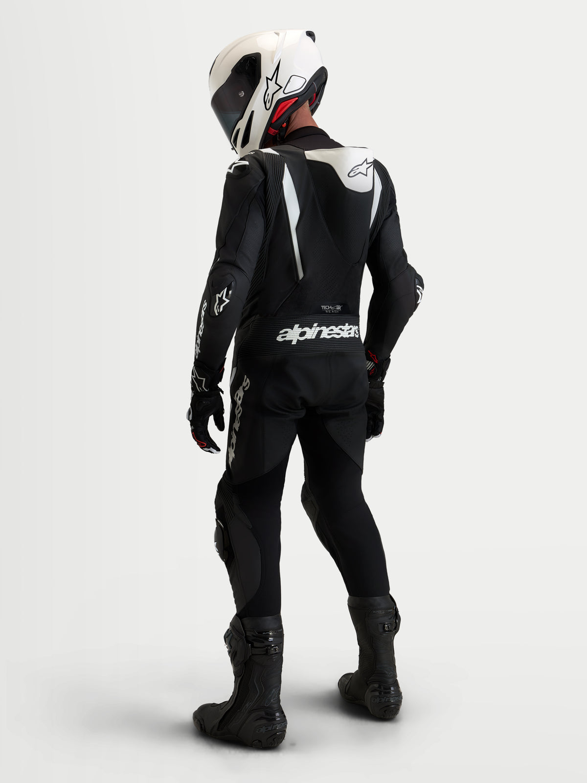 Alpinestars Missile V3 Leather Suit - 1 Piece, Black and White, men's race-grade leather motorcycle racing suit featuring an aerodynamic speed hump, DFS armor, and matching helmet, viewed from the back