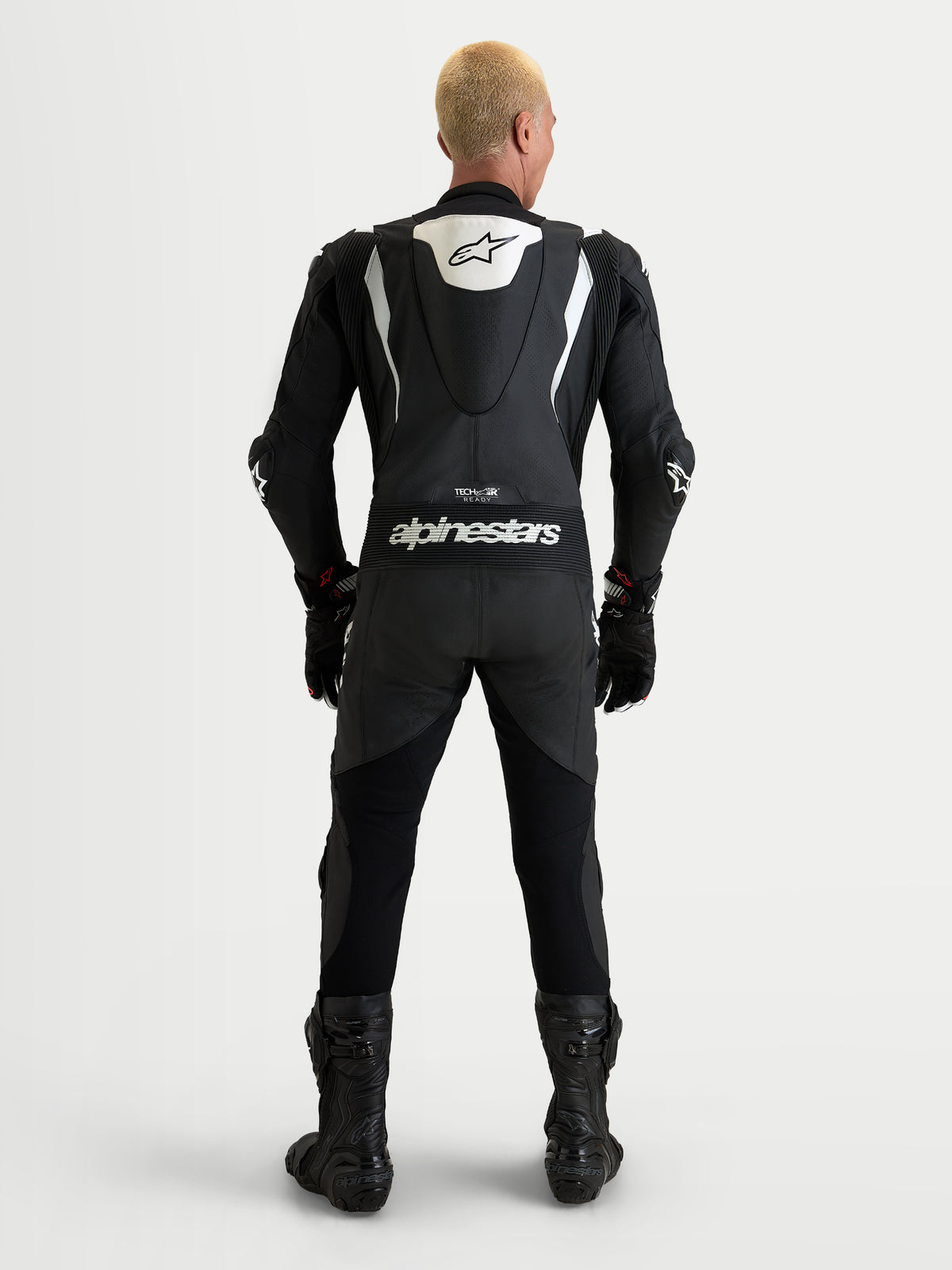 Alpinestars Missile V3 Leather Suit 1 Piece, men's black and white leather motorcycle racing suit, rear view showing aerodynamic speed hump and Alpinestars branding