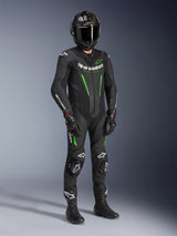Alpinestars GP Force V2 Leather Suit - 1Piece, Black and Green, worn with matching black helmet, racing gloves, and boots, featuring bright green accents and bold white Alpinestars branding, professional track and sport riding gear