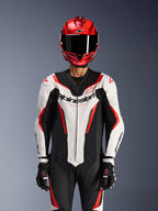 Alpinestars GP Force V2 Leather Suit - 1Piece, White Black Red Fluo, worn with red full-face helmet and black racing gloves, featuring perforated leather panels and bold Alpinestars branding on the chest, professional performance gear for motorcycle racing