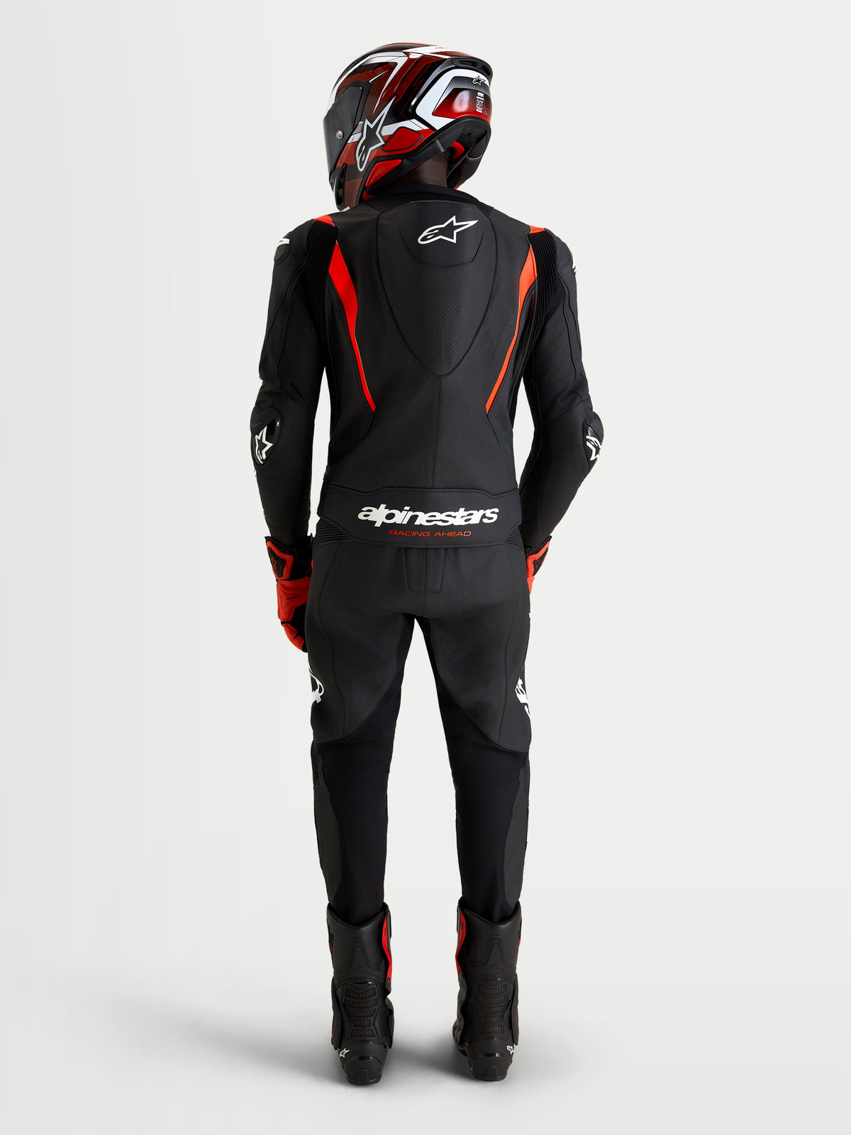 Alpinestars Missile V3 Leather Suit 2-Piece, Black and Red Fluo, men's motorcycle racing suit, rear view showing aerodynamic speed hump, CE AAA certified leather construction with stretch panels