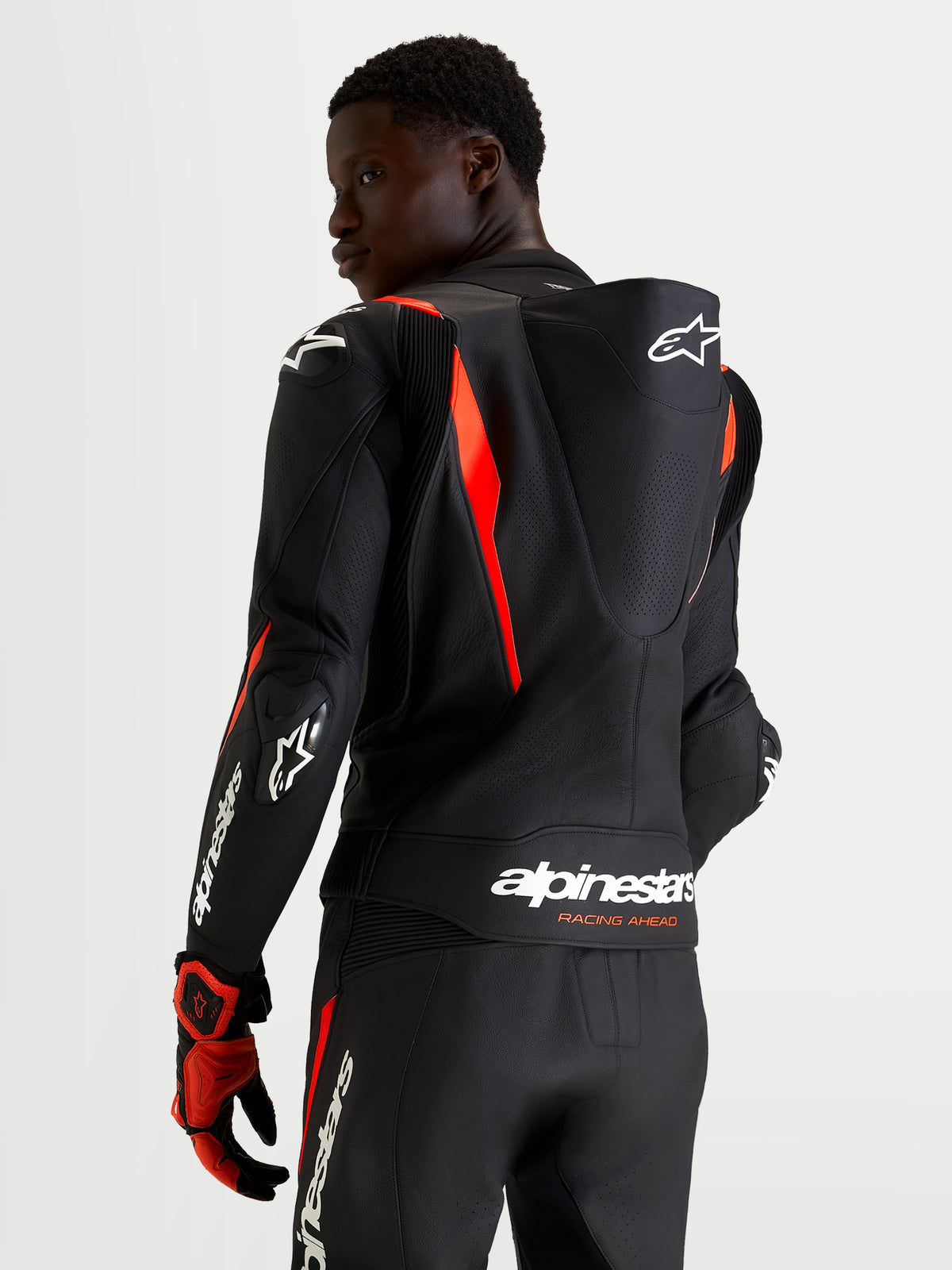 Alpinestars Missile V3 Leather Suit - 2 Piece, Black and Red Fluo, men's two-piece motorcycle racing suit featuring aerodynamic speed hump and DFS armor, rear view on model