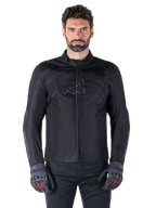 Alpinestars T-SPS V2 Waterproof Jacket, Black motorcycle textile jacket, worn by rider with black and red gloves, featuring a high collar, zippered front, and subtle chest logo, waterproof protection for sport and urban riding